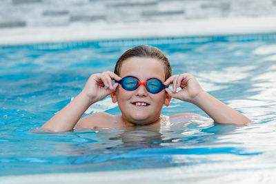 Portrait of boy swimming in pool