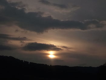 Scenic view of dramatic sky over silhouette landscape