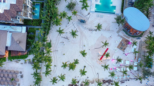 Hotel complex from height of drone. tractor on sandy beach cleaning, preparing for resort day