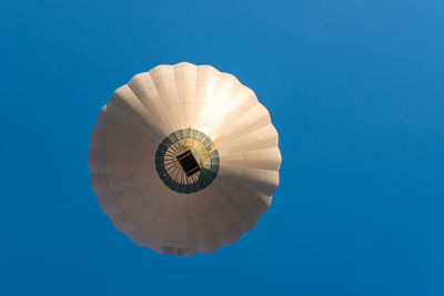 Low angle view of hot air balloon against blue sky