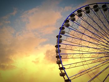 Low angle view of ferris wheel against sky