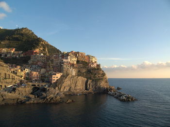 Scenic view of sea and cliff against sky