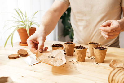 Midsection of man holding cake