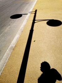 High angle view of shadow of people on street