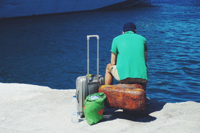 Rear view of man standing at beach