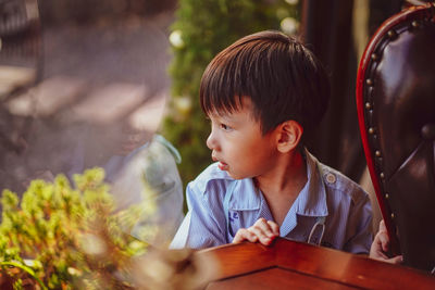 Portrait of cute girl sitting on table