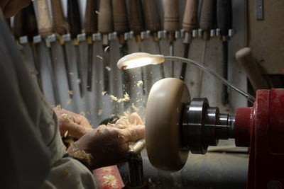 Close-up of hands working in factory