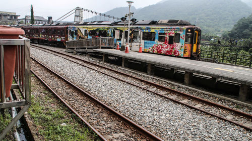 Train at railroad station platform against sky