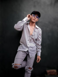 Young man wearing sunglasses standing outdoors