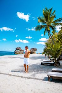 Shirtless man standing on beach