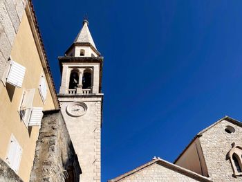 Low angle view of clock tower against sky