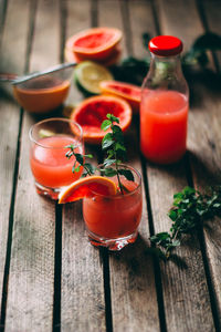 High angle view of juice in glass and bottle on table