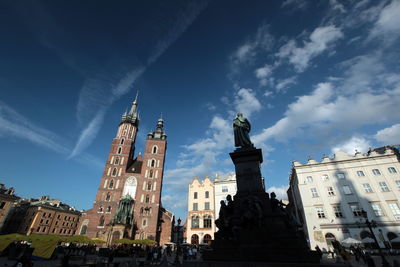 Low angle view of statue by wawel cathedral against sky
