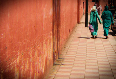 Low section of women walking on walkway