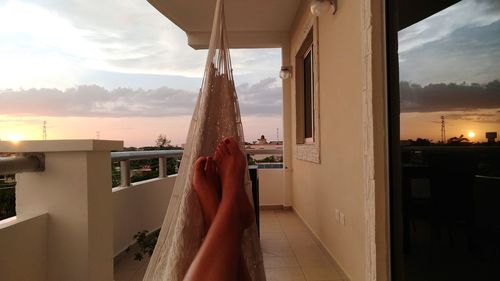Low section of woman relaxing in hammock
