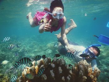 Portrait of young woman swimming in sea