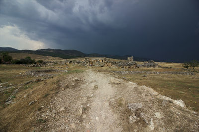 View of landscape against stormy sky