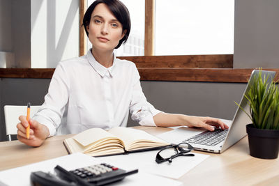 Portrait of businesswoman working at office