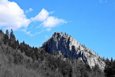 Low angle view of rocky mountain against sky