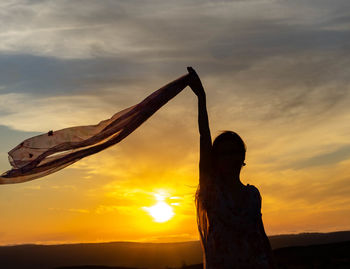 Silhouette of a woman at sunset