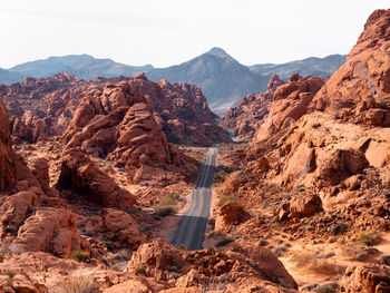 Scenic view of road amidst mountains against sky