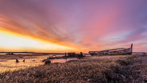 Scenic view of beach against sky during sunset