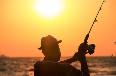 Silhouette of woman at sunset