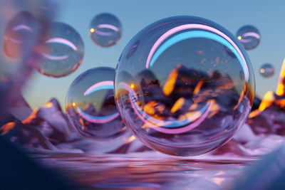 Close-up of bubbles in glass against sky