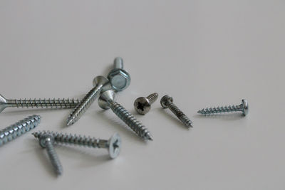 Close-up of screws on white background