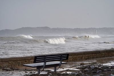 Scenic view of sea against storm sky