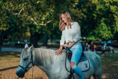 Full length of woman riding horse
