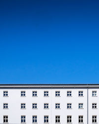 Low angle view of building against clear blue sky