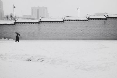 Tiled wall with snowy landscape in foreground