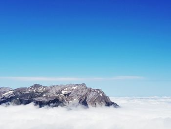 Scenic view of snowcapped mountains against clear blue sky