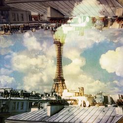 Buildings against cloudy sky