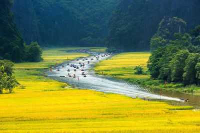 Scenic view of boats in river amidst landscape 