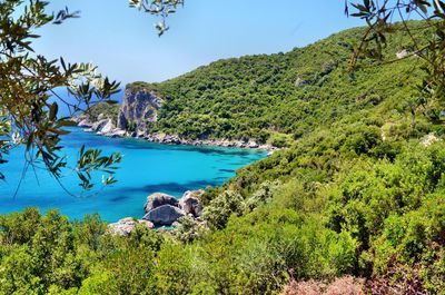 Scenic view of sea and mountains against sky