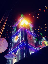 Low angle view of illuminated lights against sky at night