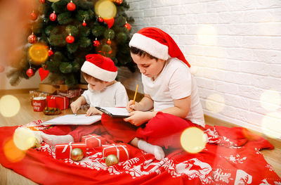 Midsection of woman with christmas tree