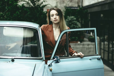 Portrait of woman looking away while sitting in car