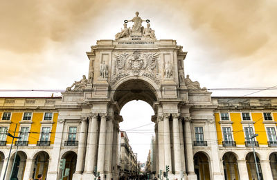 Low angle view of historical building against cloudy sky