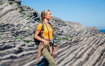 Hiking woman watching flysch rocks landscape