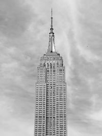 Low angle view of building against cloudy sky