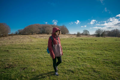 Full length of girl on field against sky