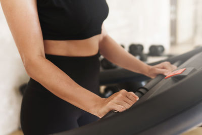 Midsection of woman standing at home