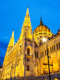 Low angle view of illuminated cathedral against sky