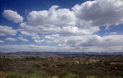 Scenic view of landscape against cloudy sky