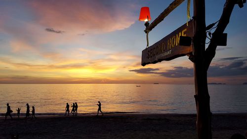 Scenic view of beach against sky during sunset