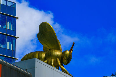 Low angle view of statue against blue sky