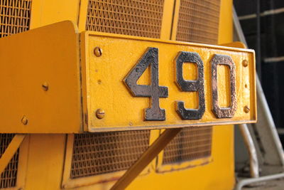 Close-up of yellow information sign